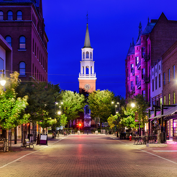 Night time view of Burlington, Vermont looking down a street toward a church steeple