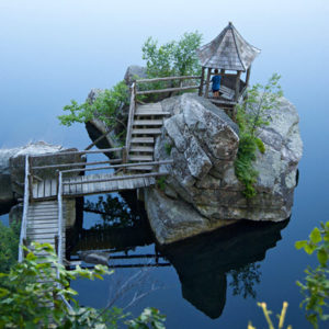 Daytime view of a gazebo built on a small island on a lake
