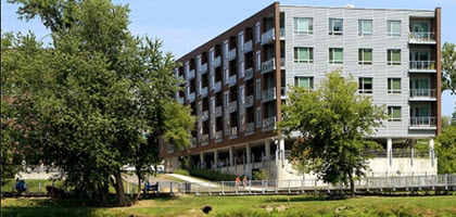 Daytime exterior view of a five story condominium building