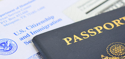 Close up view of a United States passport on a letter from the U.S. Citizenship and Immigration Services office